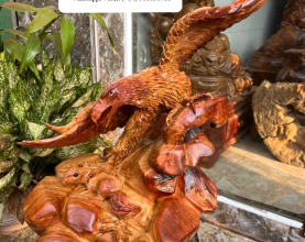 The statue is made of Vietnamese red rosewood,